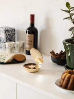 Shell votive, brass